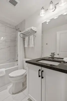 a white bathroom with a toilet and a sink at Touchstone Resort in Bracebridge