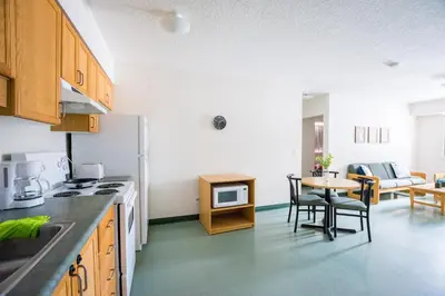 a kitchen with a table and a dining room at United College in Waterloo