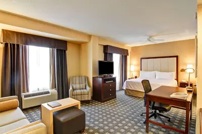 a hotel room with a bed and a desk at Homewood Suites by Hilton Toronto Mississauga in Mississauga