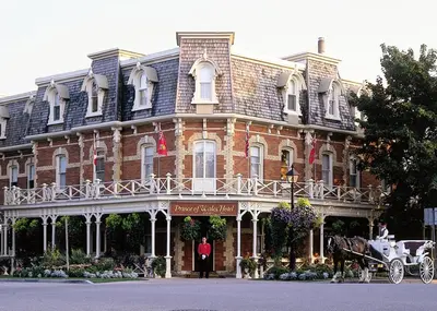a horse drawn carriage in front of a large building at Prince of Wales in Niagara on the Lake
