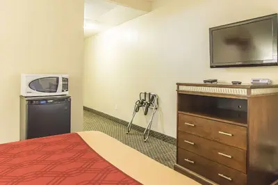 a hotel room with a bed and a microwave and a tv at Econo Lodge in Orillia