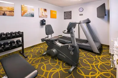 a gym with two tread machines and a treadmill at Comfort Hotel & Suites in Peterborough