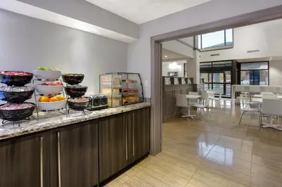 a kitchen with a counter with bowls of food at Days Inn by Wyndham Barrie in Barrie