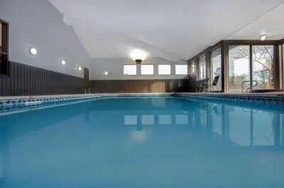 a large swimming pool with blue water at Days Inn by Wyndham Barrie in Barrie
