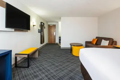 a hotel room with a bed and a couch at Comfort Inn & Suites in Barrie