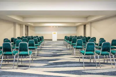 an empty conference room with green chairs in it at Comfort Inn & Suites in Barrie