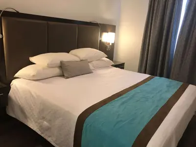 a bedroom with a large bed with white sheets and pillows at Best Western Plus Barrie in Barrie