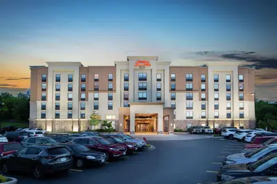 a large building with cars parked in a parking lot at Hampton Inn & Suites by Hilton Barrie in Barrie