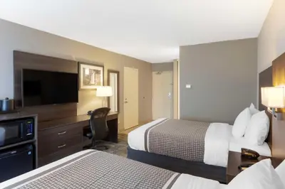 a hotel room with two beds and a flat screen tv at Best Western Milton in Milton