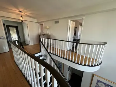 a spiral staircase in a house with a hallway at Lulu's Bed & Breakfast in Niagara on the Lake