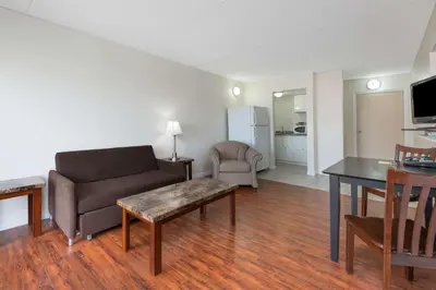 a living room with a couch and a table at Super 8 by Wyndham Cambridge/Kitchener/Waterloo Area in Cambridge