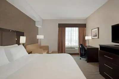 a hotel room with a bed and a desk at Holiday Inn Express Hotel & Suites Barrie by IHG in Barrie
