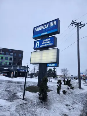 a sign for a familyway inn in the snow at Fairway Inn & Suites in Kitchener