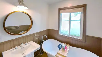 a bathroom with a sink and a mirror at Elmhirst's Resort in Keene