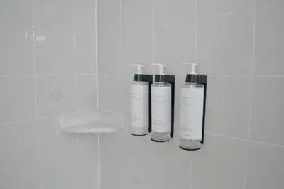 four bottles ofodorizers on a wall in a bathroom at Motel 6 Campbellford, ON in Campbellford