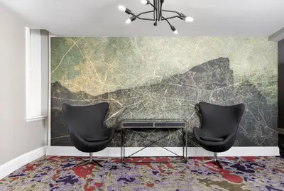 two chairs in front of a wall with a map at The Walper Hotel, part of JdV by Hyatt in Kitchener