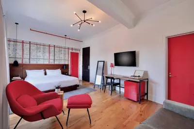 a bedroom with a bed and a desk and a chair at The Walper Hotel, part of JdV by Hyatt in Kitchener