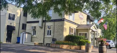 a building with two american flags in front of it at The Inn At Lock Seven in Thorold