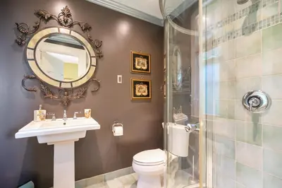 a bathroom with a toilet and a sink and a shower at Lion's Head B&B in Niagara Falls
