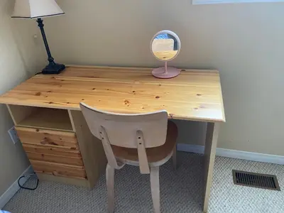 a wooden desk with a chair and a lamp at Sweet dreams in Guelph