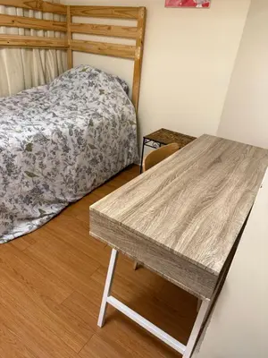 a bedroom with a bed and a wooden table at Sweet dreams in Guelph