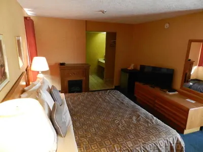 a hotel room with a bed and a television at Kings Inn Near the Falls in Niagara Falls
