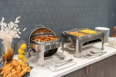 a buffet with two trays of food on a counter at Hilton Garden Inn Toronto/Brampton in Brampton
