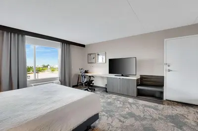 a hotel room with a bed and a flat screen tv at Hilton Garden Inn Toronto/Brampton in Brampton