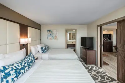 a hotel room with two beds and a flat screen tv at The Park Hotel London in London