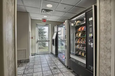 a hallway with a drink cooler in a building at Motel 6-London, ON - Ontario in London