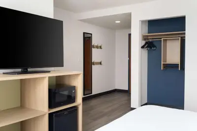 a room with a flat screen tv sitting on a shelf at Spark By Hilton Guelph in Guelph