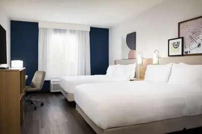 a hotel room with two beds and a tv at Spark By Hilton Guelph in Guelph