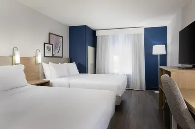 a hotel room with two beds and a tv at Spark By Hilton Guelph in Guelph
