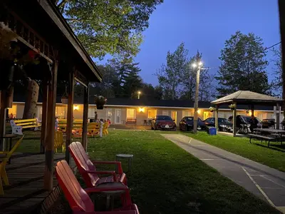a group of chairs sitting in a yard at night at Wasaga Beach Inn And Cottages in Wasaga Beach