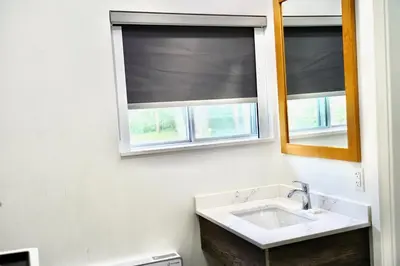 a bathroom with a sink and a window at Cedar Lane Motel in Bracebridge