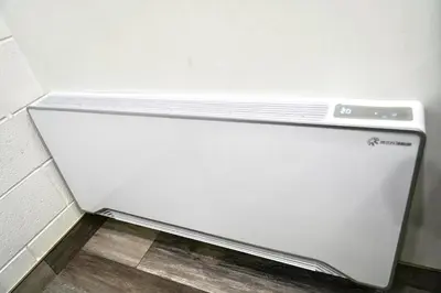 a white refrigerator freezer sitting in a room at Cedar Lane Motel in Bracebridge