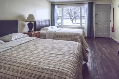 a hotel room with two beds and a window at Lakeside Inn in Orillia