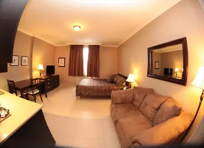 a living room with a couch and a bed at Montecassino Hotel & Event Centre in Toronto