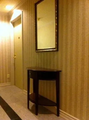 a table in a room with a mirror on the wall at Montecassino Hotel & Event Centre in Toronto