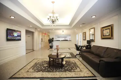 a living room with a couch and a table at Montecassino Hotel & Event Centre in Toronto