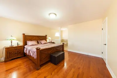 a bedroom with a bed and a wooden floor at HB Guest Home 4 in Waterloo