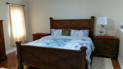 a bedroom with a large wooden bed and a window at HB Guest Home 4 in Waterloo