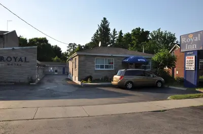 a car parked in a parking lot in front of a building at Royal Inn in Burlington