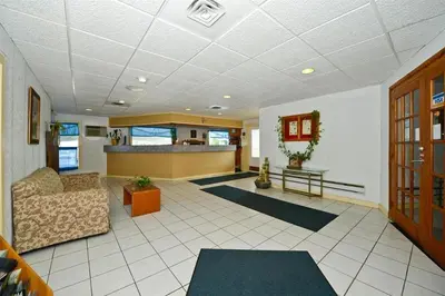 a living room with a couch and a table at Travelers Inn in Belleville