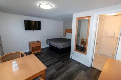 a small room with a bed and a table with a table sidx sidx at Borden Inn and Suites in Angus