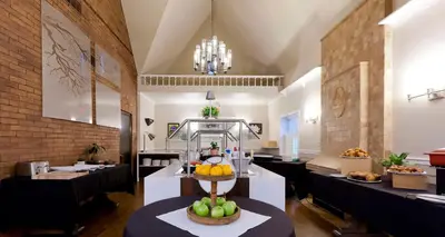 a restaurant with a display of fruit on a table at Elm Hurst Inn & Spa in Ingersoll