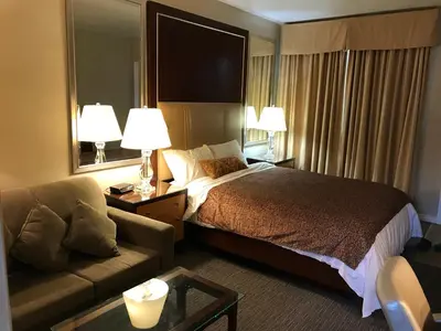 a hotel room with a bed and a couch at Cardinal Court Motel in Saint Thomas