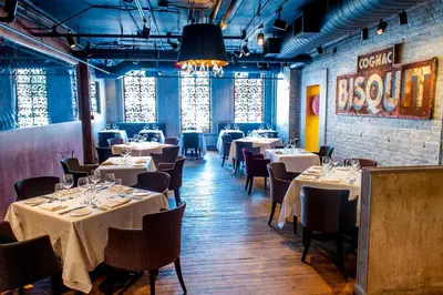 a dining room with tables and chairs with white tablecloths at The Ivy at Verity in Toronto