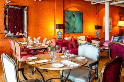 a dining room with tables and chairs and a couch at The Ivy at Verity in Toronto