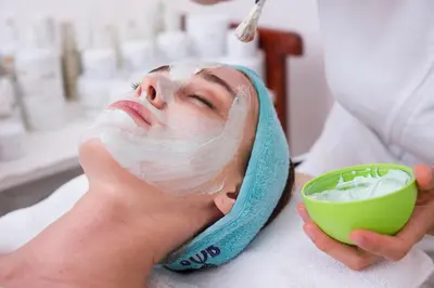 a woman getting a face mask at a spa at The Ivy at Verity in Toronto